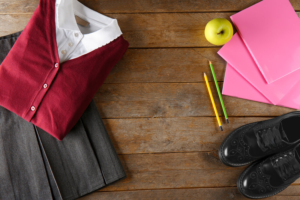 School uniform on wooden background