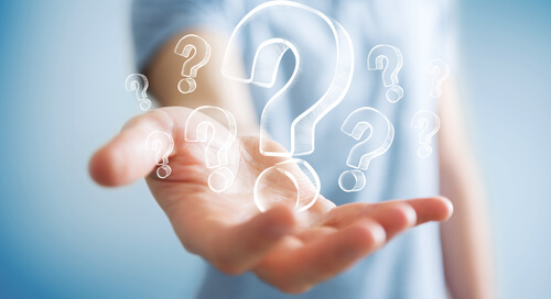 Man holding question marks