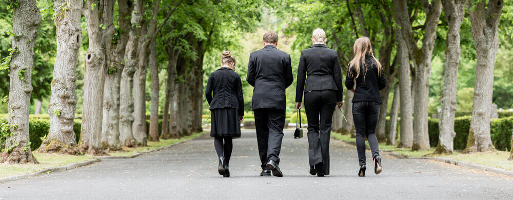 Family walking down alley graveyard