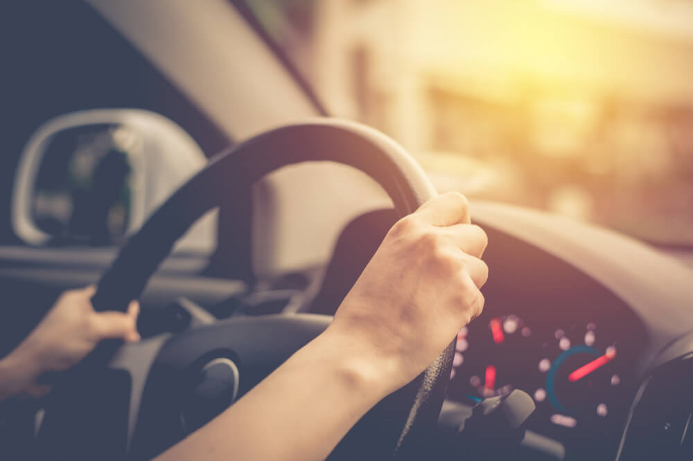 Female driving vintage car