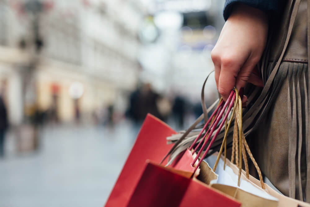 Closeup of woman holding shopping bags on the street